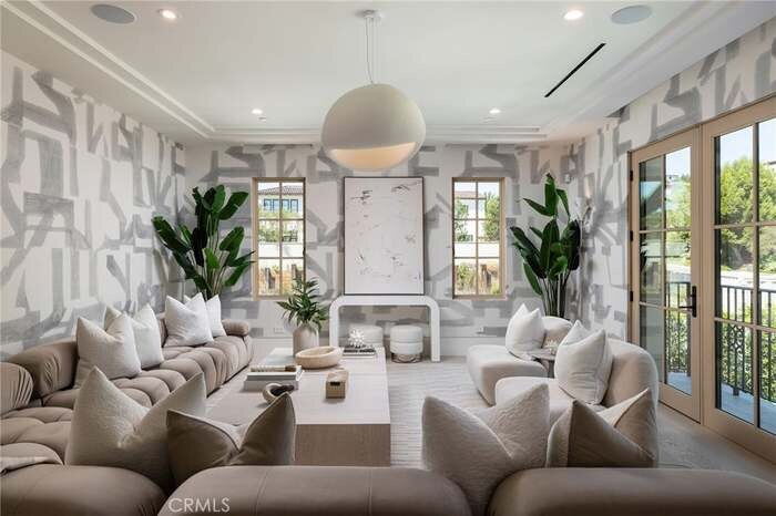 Bright lounge with upholstered seating and tall windows