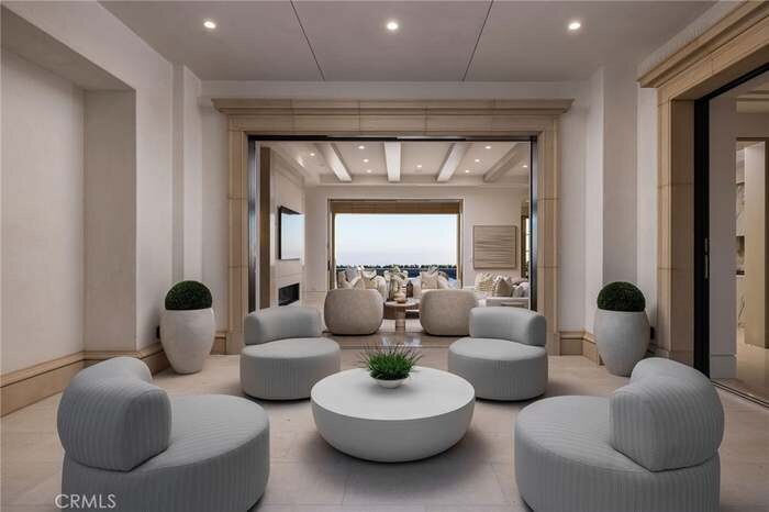 Formal sitting area with low curved seating and broad windows