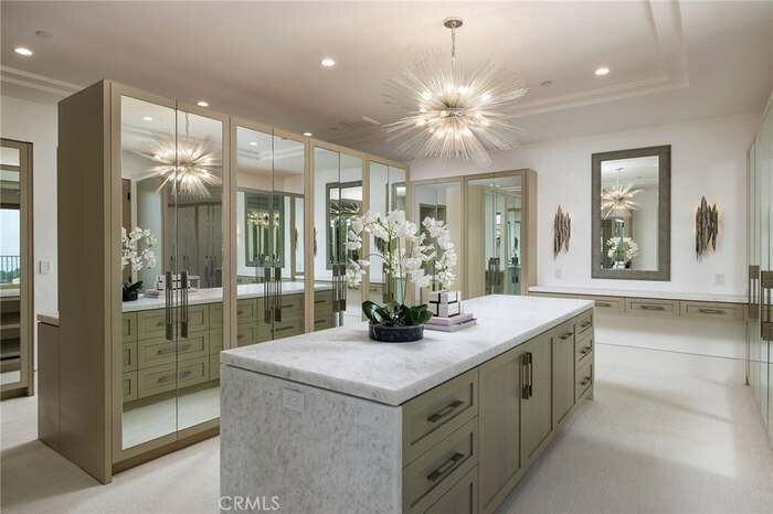 Light-filled kitchen with a stone island and glass-front cabinetry