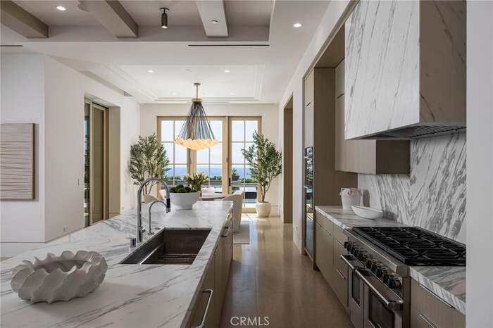 Kitchen with stone counters and a view toward the dining area