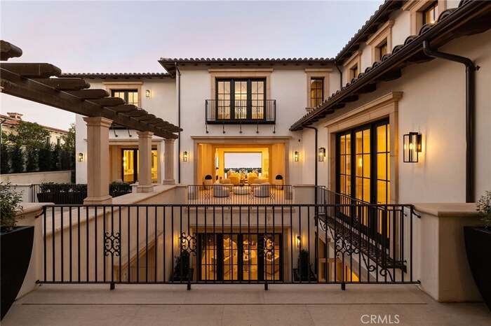 Residence exterior at dusk with warmly lit windows